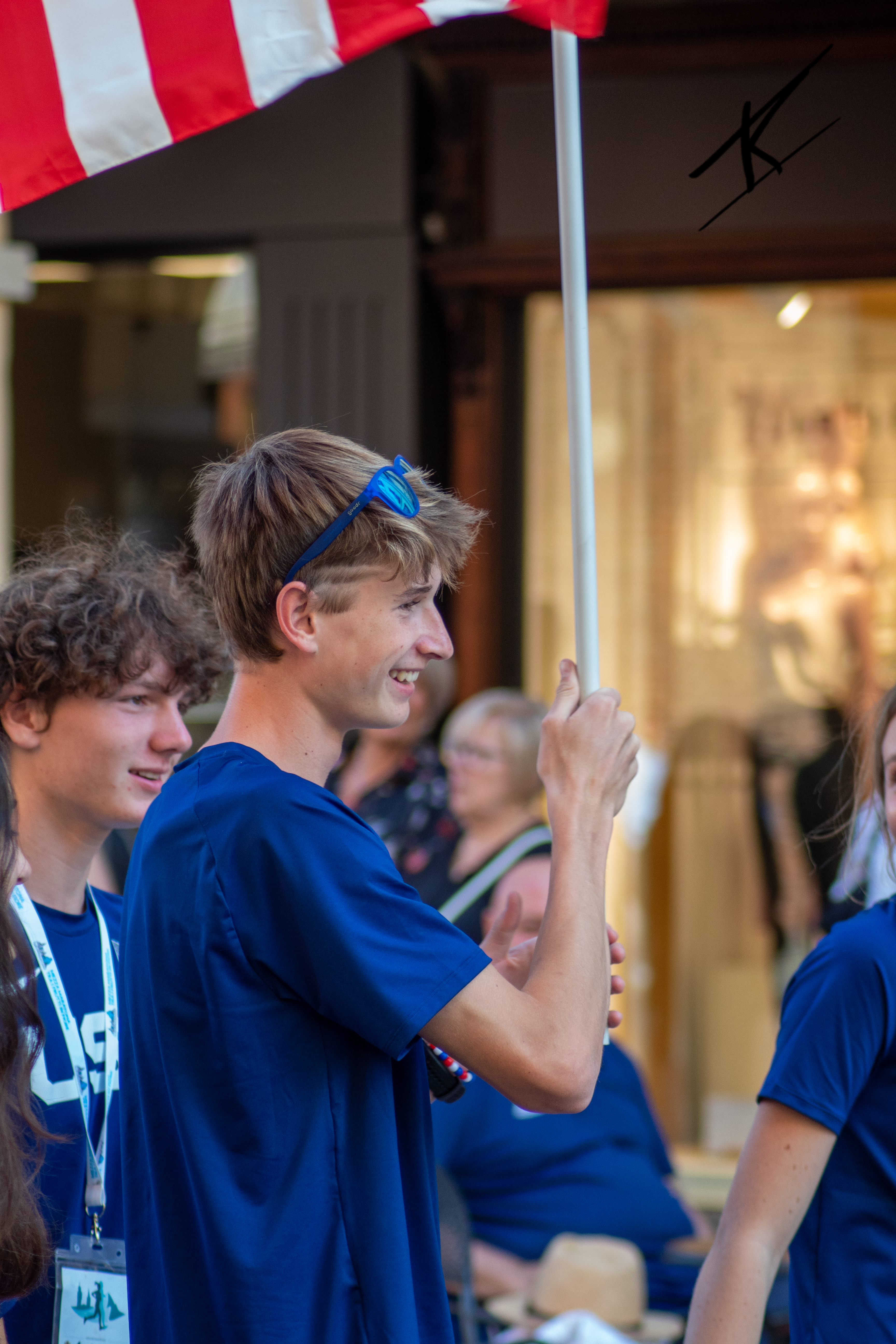 international race award ceremony usa kid holding its flag